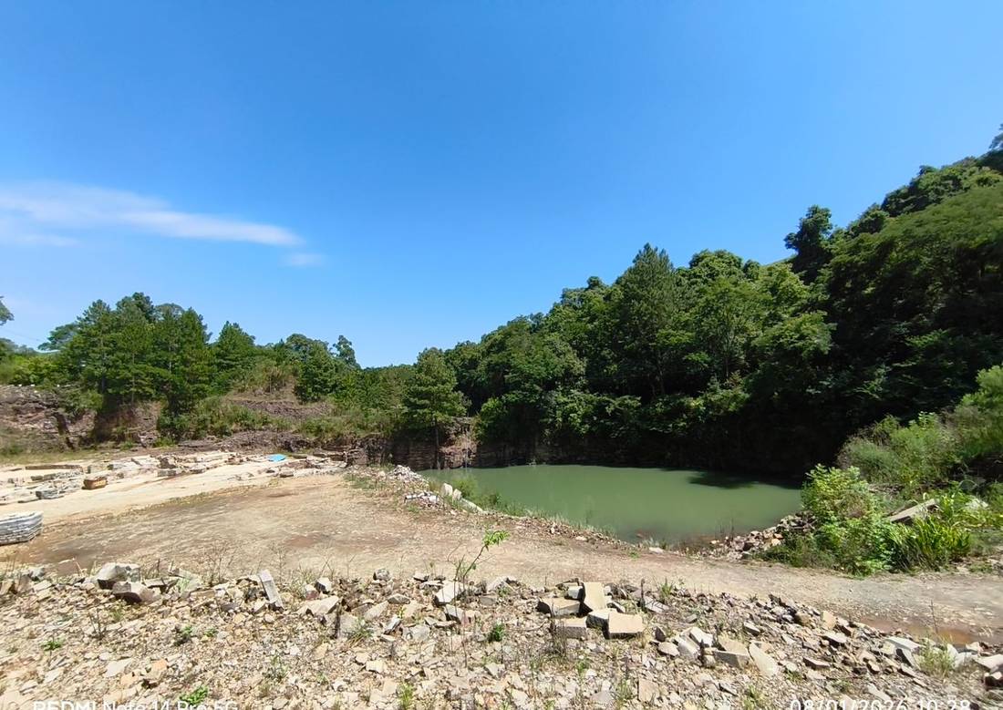 Panorama de uma cava de basalto em Nova Prata, RS, com lago de água esverdeada ao fundo